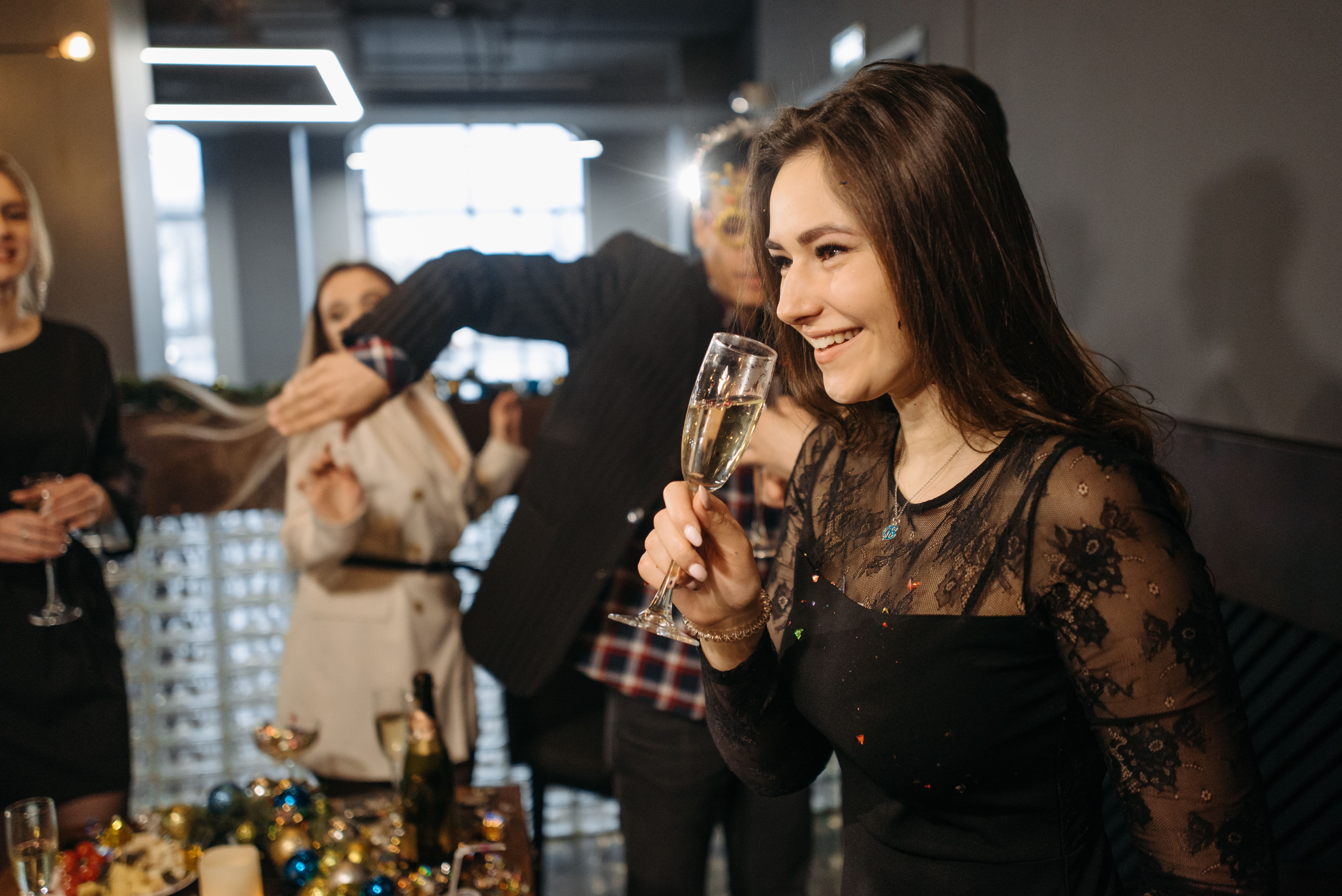 Colleagues celebrating at a lavish office party with champagne and confetti
