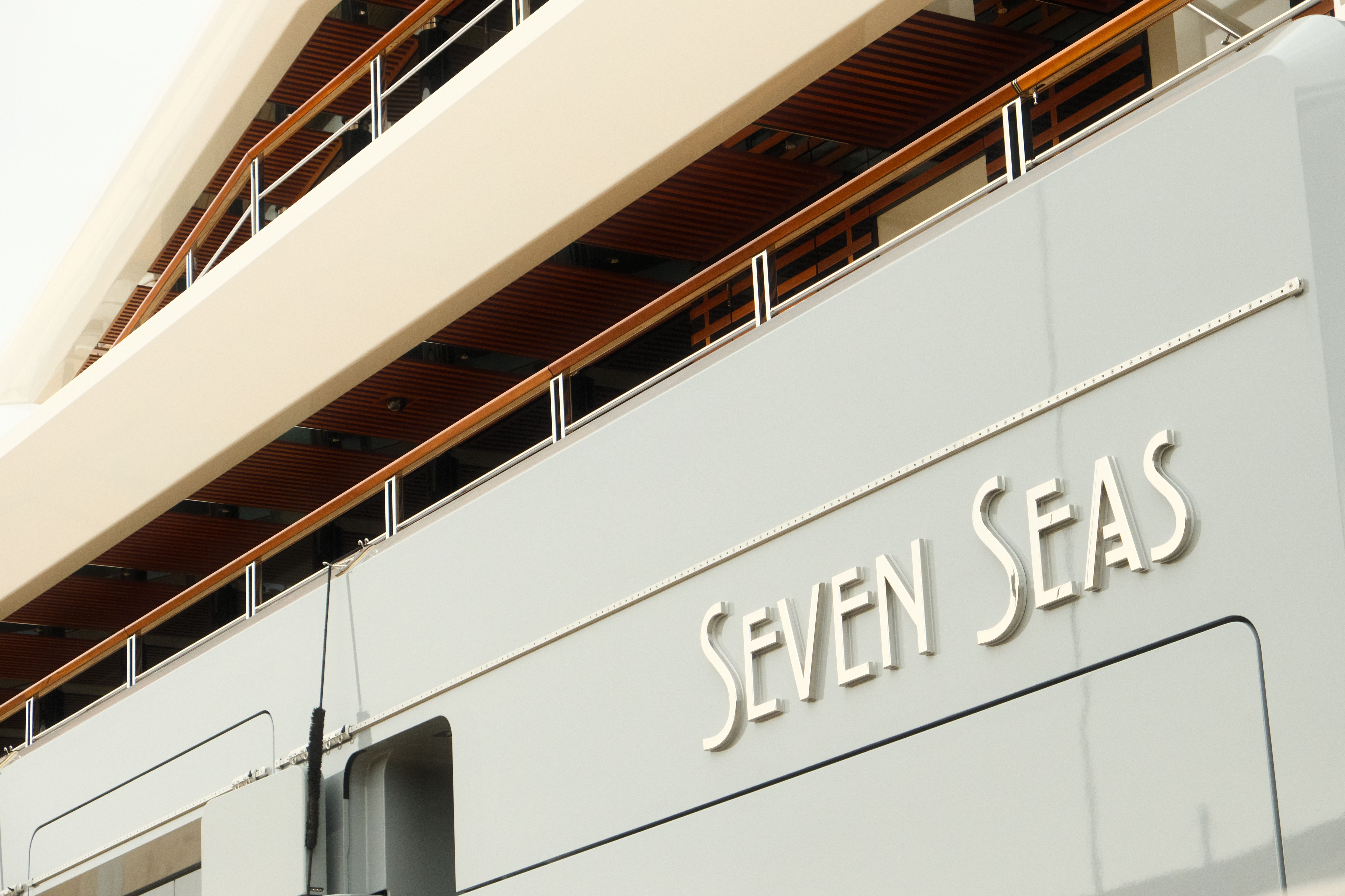 Close-up of a sleek luxury superyacht symbolizing excessive corporate spending