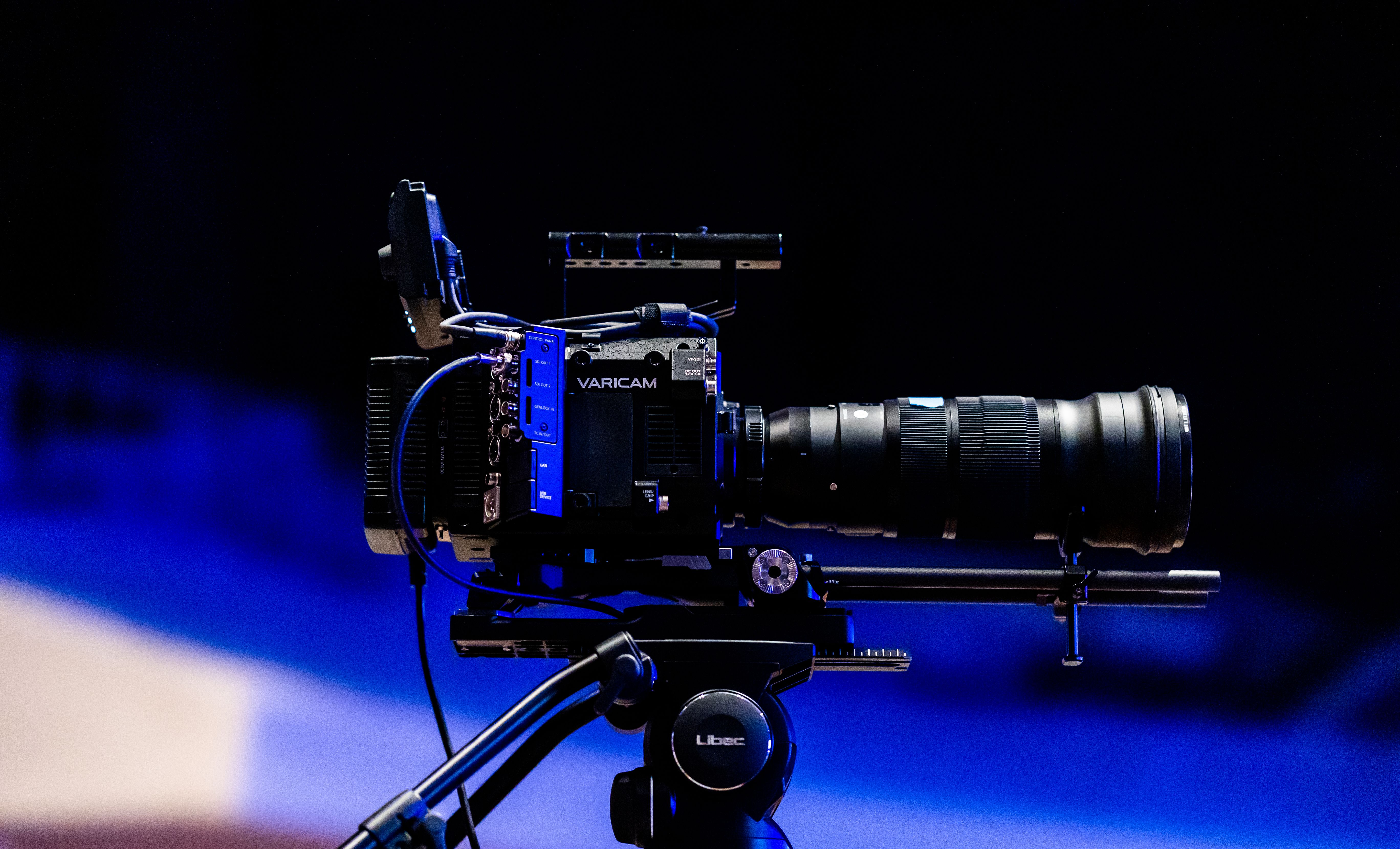 Professional video camera on a tripod, representing production work in Germany's adult entertainment industry.