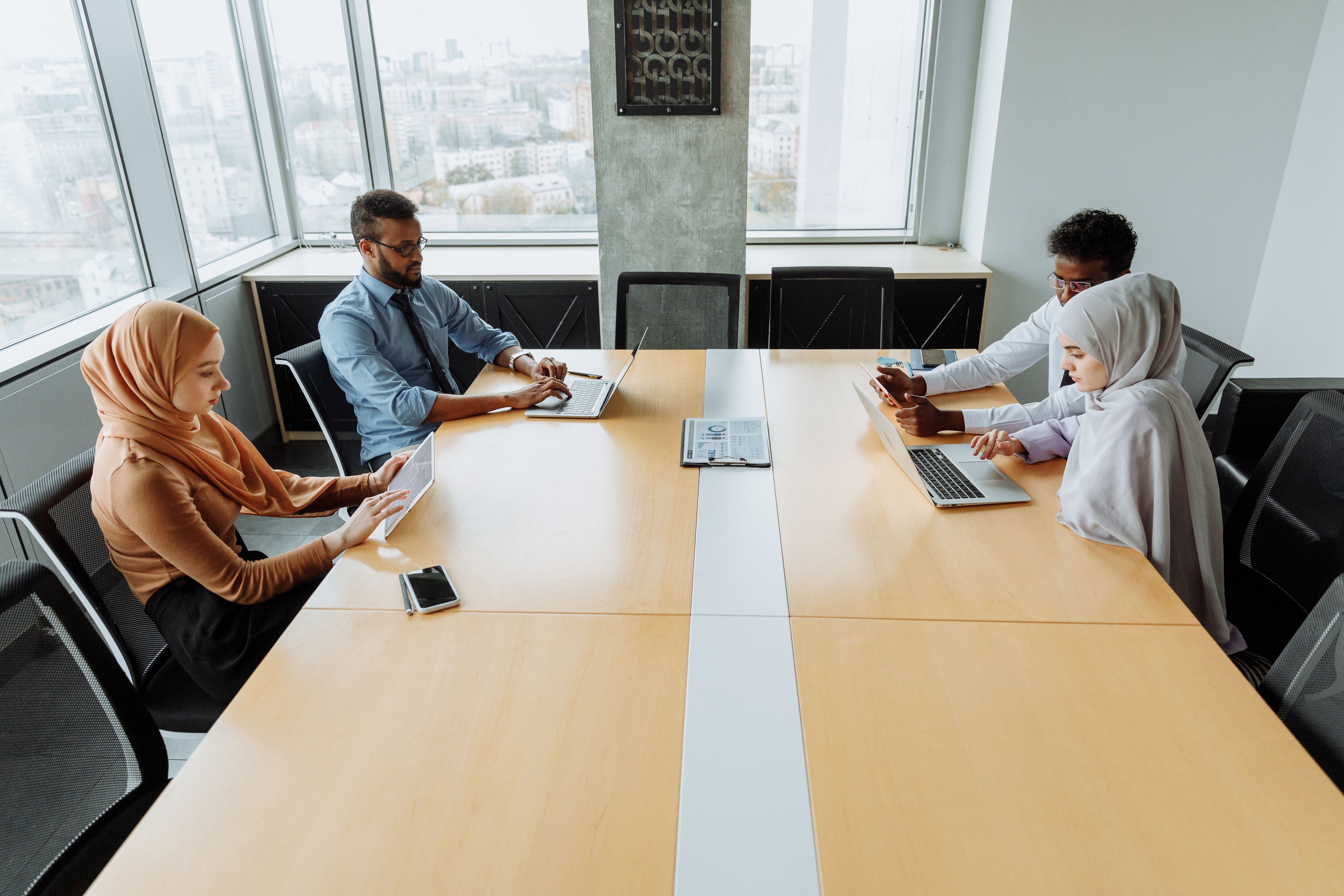 Diverse professionals collaborating in a modern office meeting room